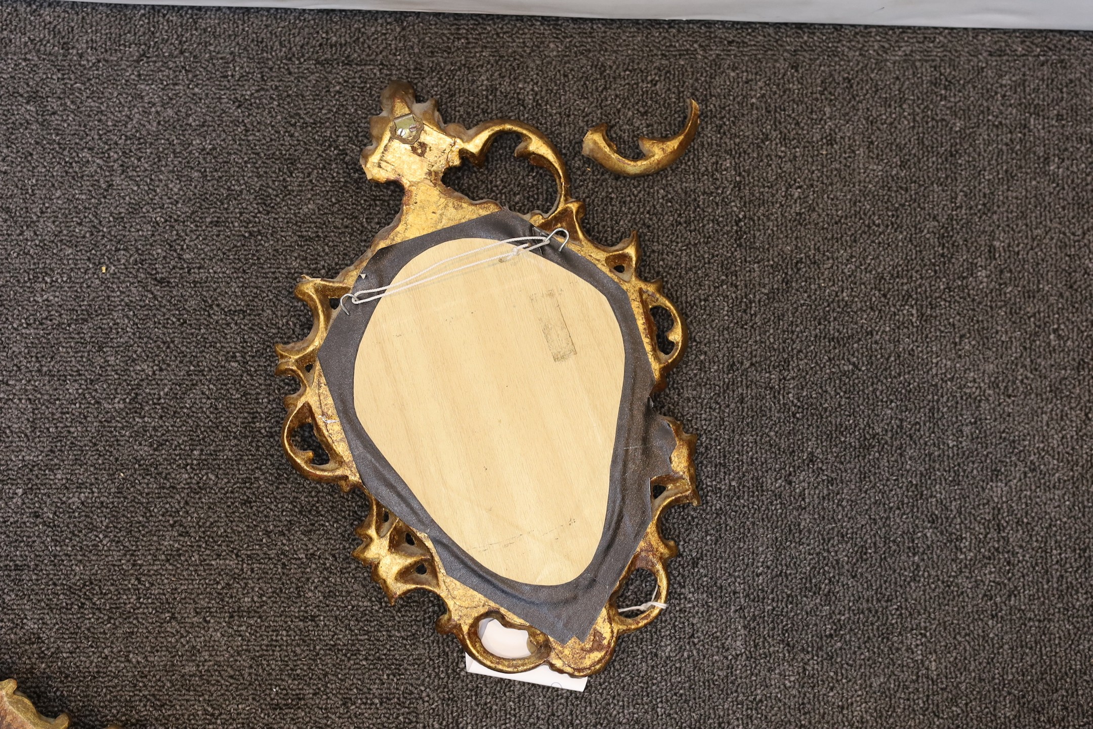 A pair of George III style giltwood cartouche wall mirrors, height 60cm, together with two similar smaller cartouche wall mirrors